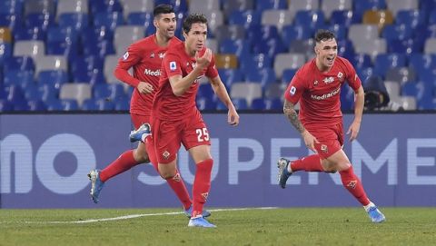 Fiorentina's Federico Chiesa, center, celebrates with teammates after scoring the first goal of the game during the Italian Serie A soccer match between Napoli and Fiorentina, at the San Paolo stadium in Naples, Italy, Saturday, Jan. 18, 2020. (Cafaro/LaPresse via AP)