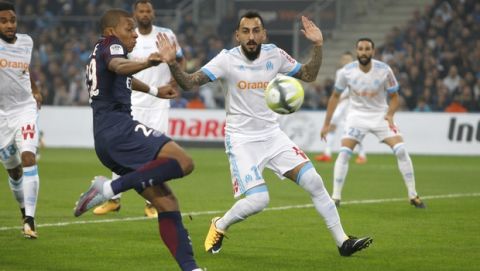 PSG's Kylian Mbappe, left, challenges for the ball with Marseille's Konstantinos Mitroglou, during the League One soccer match between Marseille and Paris Saint-Germain, at the Velodrome stadium, in Marseille, southern France, Sunday, Oct. 22, 2017. (AP Photo/Claude Paris)
