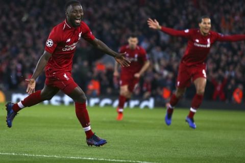 Liverpool's Naby Keita, left, celebrates after scoring the opening goal during the Champions League quarterfinal, first leg, soccer match between Liverpool and FC Porto at Anfield Stadium, Liverpool, England, Tuesday April 9, 2019. (AP Photo/Dave Thompson)