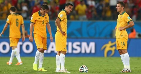 CUIABA, BRAZIL - JUNE 13:  (L-R) Mark Milligan, Tim Cahill and James Troisi of Australia wait to kickoff after allowing a third goal to Chile during the 2014 FIFA World Cup Brazil Group B match between Chile and Australia at Arena Pantanal on June 13, 2014 in Cuiaba, Brazil.  (Photo by Cameron Spencer/Getty Images)