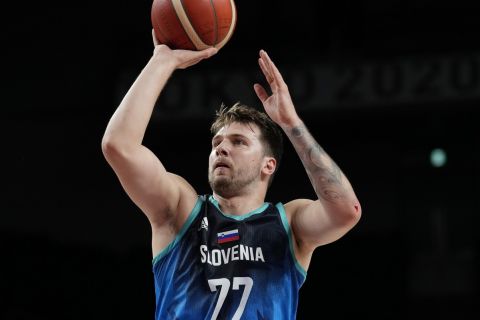 Slovenia's Luca Doncic (77) shoots against France during a men's basketball quarterfinal round game at the 2020 Summer Olympics, Thursday, Aug. 5, 2021, in Saitama, Japan. (AP Photo/Eric Gay)