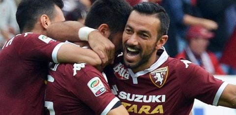 Italian midfielder of Torino FC Marco Benassi (C) celebrates with teammates after scoring the 2-0 goal lead against US Palermo during their Italian Serie A soccer match at Olimpico stadium in Turin, 27 September 2015. ANSA / DI MARCO