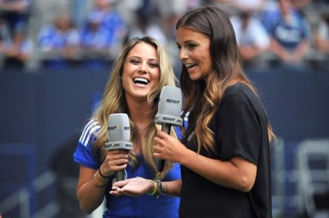 TV hosts Vanessa Huppenkothen (L) and Laura Wontorra present a TV broadcast before the beginning of the Schalke Cup soccer test match between FC Malaga and West Ham United FC at Veltins-Arena in Gelsenkirchen, Germany, 03 August 2014. The Mexican soccer reporter and Schalke fan Huppenkothen was elected the most beautiful World Cup reporter. Photo: Matthias Balk/dpa