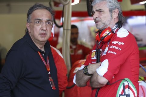 Fiat Chrysler Automobiles Chairman and CEO Sergio Marchionne, left, is flanked by Ferrari team principal Maurizio Arrivabene prior to the start of the Formula One Grand Prix of Europe at the Baku circuit, in Baku, Azerbaijan, Sunday, June 19, 2016.  (AP Photo/Luca Bruno) 