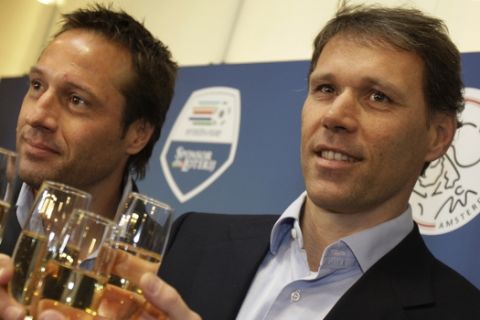 John van 't Schip, left, and Marco van Basten, right, propose a toast during a press conference at Arena stadium in Amsterdam, Netherlands, Wednesday, March 5, 2008. Van Basten was presented to the press as the new coach of Ajax for the new season. Van Basten and his assistant John van 't Schip take over at Ajax after leading the Netherlands for four years. The will quit the Dutch national side after the European Championship in Austria and Switzerland in June. (AP Photo/ Bas Czerwinski)