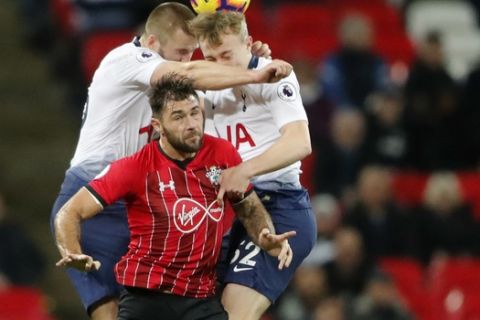 Tottenham's Eric Dier, left, Tottenham's Oliver Skipp, right, and Southampton's Charlie Austin challenge for the ball during the English Premier League soccer match between Tottenham Hotspur and Southampton at Wembley Stadium in London, Wednesday, Dec. 5, 2018. (AP Photo/Frank Augstein)