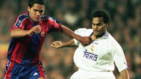 Barcelona's Brazilian striker Giovanni Silva (left) fights for the ball against Real Madrid's Christian Karembeu during a league soccer match in Barcelona Saturday March 7, 1998. Barcelona won the game 3-0. (AP Photo/Cesar Rangel).