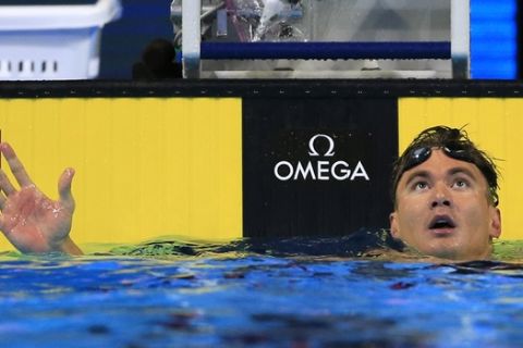 Nathan Adrian checks his time after swimming in the semifinals of the men's 100-meter freestyle at the U.S. Olympic swimming trials in Omaha, Neb., Wednesday, June 29, 2016. (AP Photo/Orlin Wagner)