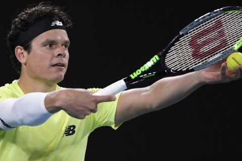 Canada's Milos Raonic prepares to serve to Serbia's Novak Djokovic during their quarterfinal match at the Australian Open tennis championship in Melbourne, Australia, Tuesday, Jan. 28, 2020. (AP Photo/Andy Brownbill)