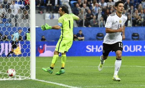 Germany's Lars Stindl, right, celebrates after scoring the opening goal past Chile goalkeeper Claudio Bravo, left, during the Confederations Cup final soccer match between Chile and Germany, at the St.Petersburg Stadium, Russia, Sunday July 2, 2017. (AP Photo/Martin Meissner)