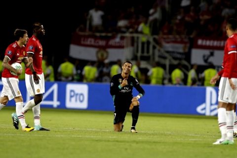 Real Madrid's Cristiano Ronaldo, smiles on one knee in the middle of various Manchester United player during the Super Cup final soccer match between Real Madrid and Manchester United at Philip II Arena in Skopje, Tuesday, Aug. 8, 2017. (AP Photo/Thanassis Stavrakis)