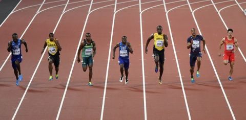 United States' Justin Gatlin, left, races in the Men's 100 meters final during the World Athletics Championships in London Saturday, Aug. 5, 2017. (AP Photo/Martin Meissner)