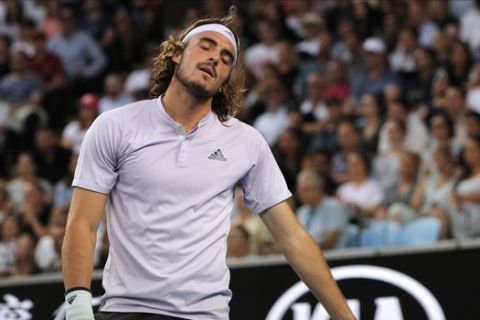 Greece's Stefanos Tsitsipas reacts during his third round singles match against Canada's Milos Raonic at the Australian Open tennis championship in Melbourne, Australia, Friday, Jan. 24, 2020. (AP Photo/Andy Wong)