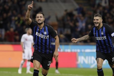 Inter Milan's Danilo D'Ambrosio, left, celebrates with his teammate Mauro Icardi after scoring his side's second goal during the Serie A soccer match between Inter Milan and Fiorentina, at the San Siro stadium in Milan, Italy, Tuesday, Sept. 25, 2018. (AP Photo/Luca Bruno)