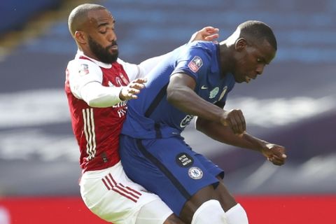 Arsenal's Alexandre Lacazette, left, challenges for the ball with Chelsea's Kurt Zouma uring the FA Cup final soccer match between Arsenal and Chelsea at Wembley stadium in London, England, Saturday, Aug.1, 2020. (Catherine Ivill/Pool via AP)