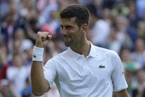 Serbia's Novak Djokovic celebrates defeating Australia's Jordan Thompson in the men's singles match on day three of the Wimbledon tennis championships in London, Wednesday, July 5, 2023. (AP Photo/Alastair Grant)