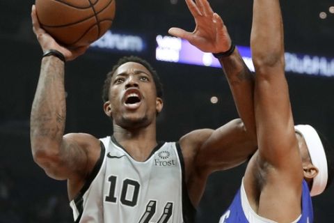 San Antonio Spurs guard DeMar DeRozan, left, drives to the basket past Los Angeles Clippers forward Tobias Harris during the first half of an NBA basketball game in Los Angeles, Thursday, Nov. 15, 2018. (AP Photo/Chris Carlson)
