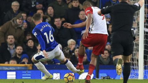 Everton's James McCarthy, left, gets injured after attempting to block a shot from West Bromwich Albion's Salomon Rondon  during their English Premier League soccer match at Goodison Park, Liverpool, England, Saturday, Jan. 20, 2018. (Peter Byrne/PA via AP)