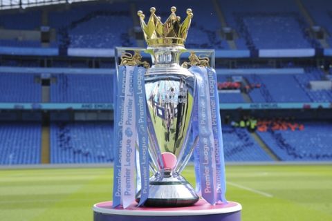FILE - In this Sunday, May 6, 2018 file photo the English Premier League trophy sits on the pitch prior to the English Premier League soccer match between Manchester City and Huddersfield Town at Etihad stadium in Manchester, England. Matches in England will be stopped until at least April 3 after five Premier League clubs said some players or staff were in self-isolation. Arsenal manager Mikel Arteta has tested positive for the virus, as has Chelsea winger Callum Hudson-Odoi. (AP Photo/Rui Vieira, File)