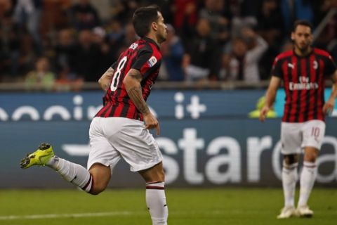 AC Milan's Suso runs after scoring the opening goal against Bologna during the Italian Serie A soccer match between AC Milan and Bologna at the San Siro stadium, in Milan, Italy, Monday, May 6, 2019. (AP Photo/Antonio Calanni)