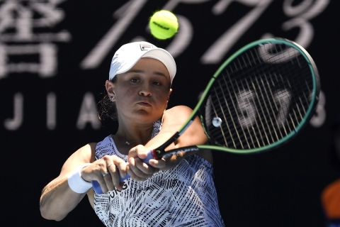 Ash Barty of Australia plays a backhand return to Lucia Bronzetti of Italy during their second round match at the Australian Open tennis championships in Melbourne, Australia, Wednesday, Jan. 19, 2022. (AP Photo/Andy Brownbill)