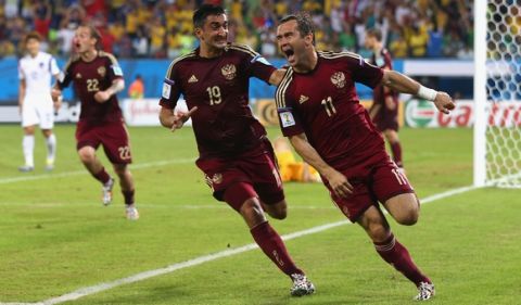 CUIABA, BRAZIL - JUNE 17: Aleksandr Kerzhakov of Russia (R) celebrates scoring his team's first goal with Alexander Samedov during the 2014 FIFA World Cup Brazil Group H match between Russia and South Korea at Arena Pantanal on June 17, 2014 in Cuiaba, Brazil.  (Photo by Elsa/Getty Images)