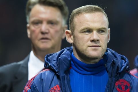 Manchester United's Wayne Rooney, right, makes his way to the substitutes bench ahead of manager Louis van Gaal  before the English League Cup soccer match berween Manchester United and Middlesbrough at Old Trafford Stadium, Manchester, England, Wednesday Oct. 28, 2015. (AP Photo/Jon Super)  