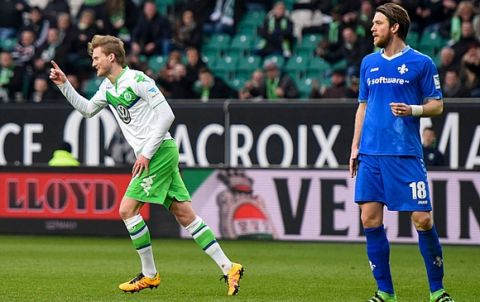 WOLFSBURG, GERMANY - MARCH 19:  Andre Schuerrle of Wolfsburg celebrates scoring his goal next to Peter Niemeyer of Darmstadt during the Bundesliga match between VfL Wolfsburg and Hertha BSC Berlin at Volkswagen Arena on March 19, 2016 in Wolfsburg, Germany.  (Photo by Nigel Treblin/Bongarts/Getty Images)