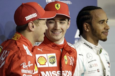 Ferrari driver Charles Leclerc of Monaco, center, celebrates his pole position with runner up Ferrari driver Sebastian Vettel of Germany, left and Mercedes driver Lewis Hamilton of Britain after the qualifying session at the Formula One Bahrain International Circuit in Sakhir, Bahrain, Saturday, March 30, 2019. The Bahrain Formula One Grand Prix will take place on Sunday. (AP Photo/Luca Bruno)