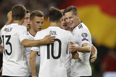 Germany's Julian Draxler, right, celebrates with his teammates after scoring his side's second goal during the World Cup Group C qualifying soccer match between Germany and Norway in Stuttgart, Germany, Monday, Sept. 4, 2017. (AP Photo/Matthias Schrader)
