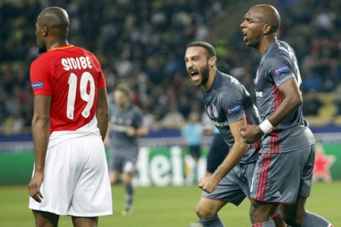 Besiktas' Cenk Tosun, 2nd right, celebrates his side's first goal with his teammate Ryan Babel during the Champions League Group G first leg soccer match between Monaco and Besiktas at Louis II stadium in Monaco, Tuesday, Oct. 17, 2017. (AP Photo/Claude Paris)