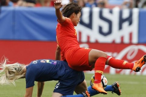 China's Wang Shuang (7) is upended by United States' Julie Ertz (2) in the first half during an international friendly soccer match, Tuesday, June 12, 2018, in Cleveland. The United States defeated China 2-1. (AP Photo/Ron Schwane)