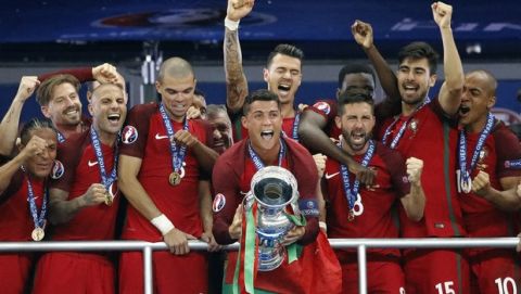 Portugal's Cristiano Ronaldo , center, after the Euro 2016 final soccer match between Portugal and France at the Stade de France in Saint-Denis, north of Paris, Sunday, July 10, 2016. (AP Photo/Frank Augstein)