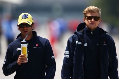 SHANGHAI, CHINA - APRIL 12:  Teammates Felipe Nasr of Brazil and Sauber F1 and Marcus Ericsson of Sweden and Sauber F1 walk across the paddock during the Formula One Grand Prix of China at Shanghai International Circuit on April 12, 2015 in Shanghai, China.  (Photo by Clive Mason/Getty Images)