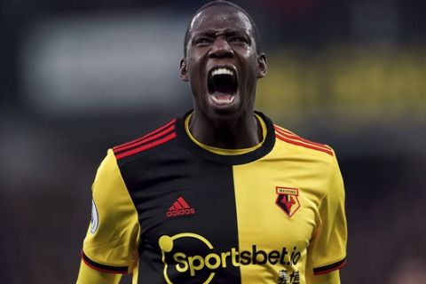 Watford's Abdoulaye Doucoure celebrates scoring against Aston Villa during the English Premier League soccer match at Vicarage Road, Watford, England, Saturday Dec. 28, 2019. (Tess Derry/PA via AP)