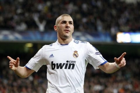 Real Madrid's Karim Benzema celebrates his goal against Olympique Lyon during their second leg round of 16 Champions League soccer match  at Santiago Bernabeu stadium in Madrid March 16, 2011.       REUTERS/Sergio Perez (SPAIN  - Tags: SPORT SOCCER)