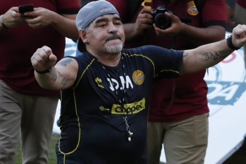 Former soccer great Diego Maradona says goodbye to the fans in stands, after a training session at the Dorados de Sinaloa soccer club stadium, after Maradona was presented as the new manager of the Dorados in Culiacan, Mexico, Monday, Sept. 10, 2018. Maradona, whose public battles with cocaine made him soccer's poster child for the perils of substance abuse, is setting up camp in Mexico's drug cartel heartland as the new coach of a second-tier team. (AP Photo/Marco Ugarte)