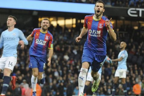Crystal Palace's Luka Milivojevic celebrates with his teammates after scoring his side's third goal during the English Premier League soccer match between Manchester City and Crystal Palace at Etihad stadium in Manchester, England, Saturday, Dec. 22, 2018. (AP Photo/Rui Vieira)