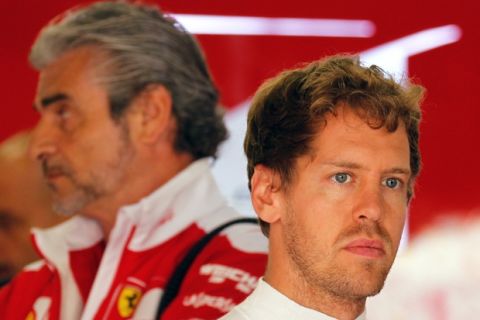 Ferrari driver Sebastian Vettel of Germany, right, stands near his team principal Maurizio Arrivabene during the third practice session for the Chinese Formula One Grand Prix at Shanghai International Circuit in Shanghai, China, Saturday, April 16, 2016. (AP Photo)