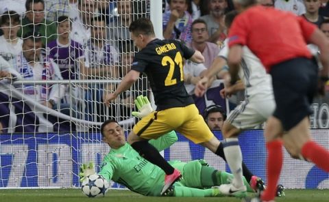 Real Madrid's goalkeeper Keylor Navas, left, dives for a save in front of Atletico's Kevin Gameiro during the Champions League semifinals first leg soccer match between Real Madrid and Atletico Madrid at Santiago Bernabeu stadium in Madrid, Spain, Tuesday May 2, 2017. (AP Photo/Daniel Ochoa de Olza)