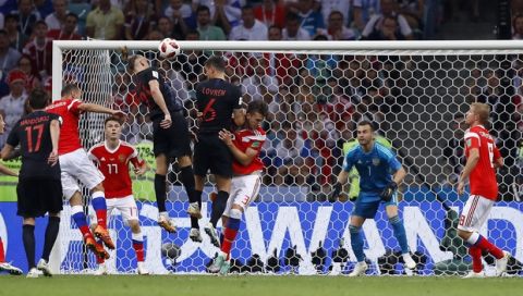 Croatia's Domagoj Vida, third from left, jumps for the ball as he tries to score during the quarterfinal match between Russia and Croatia at the 2018 soccer World Cup in the Fisht Stadium, in Sochi, Russia, Saturday, July 7, 2018. (AP Photo/Manu Fernandez)