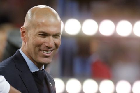 FILE - In this May 26, 2018 photo Real Madrid coach Zinedine Zidane smiles after winning the Champions League Final soccer match between Real Madrid and Liverpool at the Olimpiyskiy Stadium in Kiev. (AP Photo/Efrem Lukatsky, file)