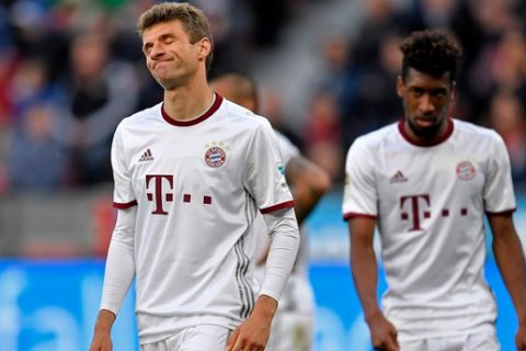 Bayern's Thomas Mueller, left, reacts during the German Bundesliga soccer match between Bayer Leverkusen and Bayern Munich in Leverkusen, Germany, Saturday, April 15, 2017. (AP Photo/Martin Meissner)