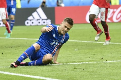 Iceland's Arnor Ingvi Traustason celebrates scoring his team's second goal during the Euro 2016 Group F soccer match between Iceland and Austria at the Stade de France in Saint-Denis, north of Paris, France, Wednesday, June 22, 2016. (AP Photo/Martin Meissner)