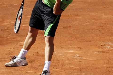 Marcos Baghdatis of Cyprus serves to Rafael Nadal of Spain during their Madrid Open tennis match May 4, 2011. REUTERS/Juan Medina (SPAIN - Tags: SPORT TENNIS)