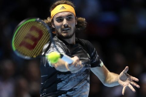 Stefanos Tsitsipas of Greece plays a return to Daniil Medvedev of Russia during their ATP World Tour Finals singles tennis match at the O2 Arena in London, Monday, Nov. 11, 2019. (AP Photo/Kirsty Wigglesworth)