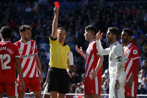 Real Madrid's Sergio Ramos, second right, receives a red card during a La Liga soccer match between Real Madrid and Girona at the Bernabeu stadium in Madrid, Spain, Sunday, Feb. 17, 2019. (AP Photo/Andrea Comas)