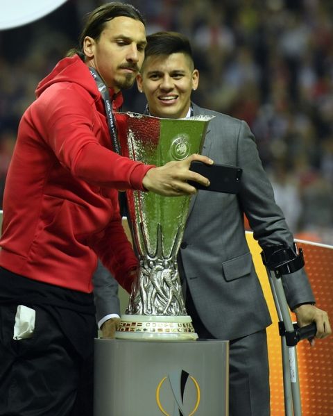 United's Zlatan Ibrahimovic, left, and Marcos Rojo take a selfie with the trophy after winning the soccer Europa League final between Ajax Amsterdam and Manchester United at the Friends Arena in Stockholm, Sweden, Wednesday, May 24, 2017. United won 2-0. (AP Photo/Martin Meissner)