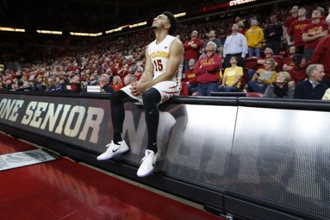 Iowa State guard Naz Mitrou-Long sits on the scorer's table as he watches a senior night video tribute after an NCAA college basketball game against Oklahoma State, Tuesday, Feb. 28, 2017, in Ames, Iowa. Iowa State won 86-83. (AP Photo/Charlie Neibergall)