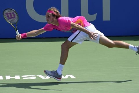 Stefanos Tsitsipas, or Greece, returns the ball to Alexander Zverev, of Germany, during the semifinals of the Citi Open tennis tournament in Washington, Saturday, Aug. 4, 2018. Zverev defeated Tsitsipas, 6-2, 6-4, to advance to the finals. (AP Photo/Susan Walsh)